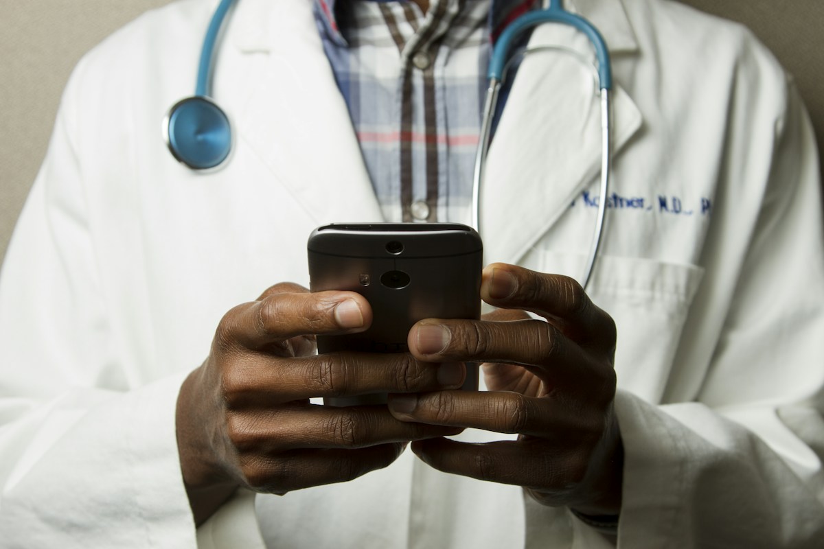 A medical professional using a phone
